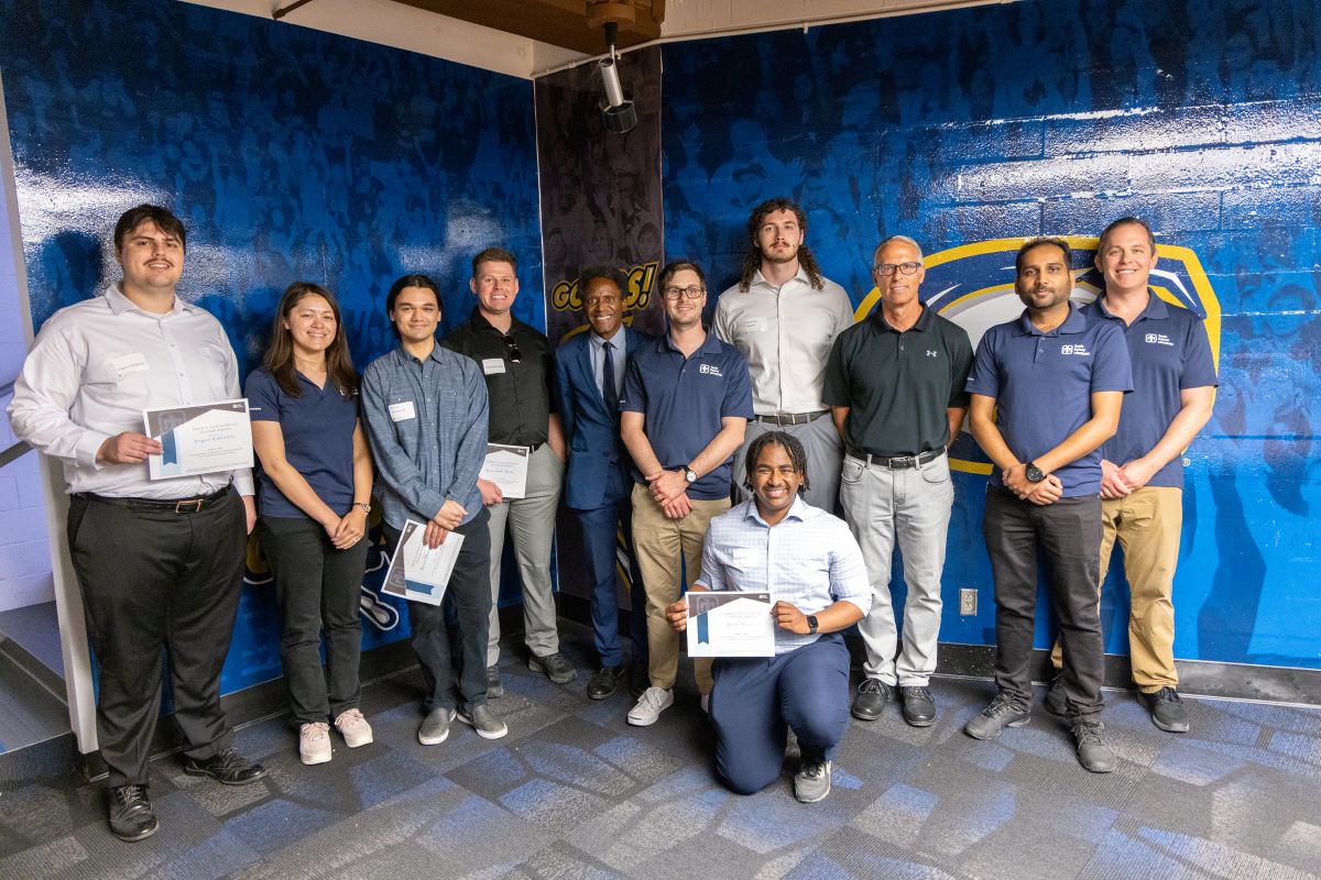 Team members stand for a group photo