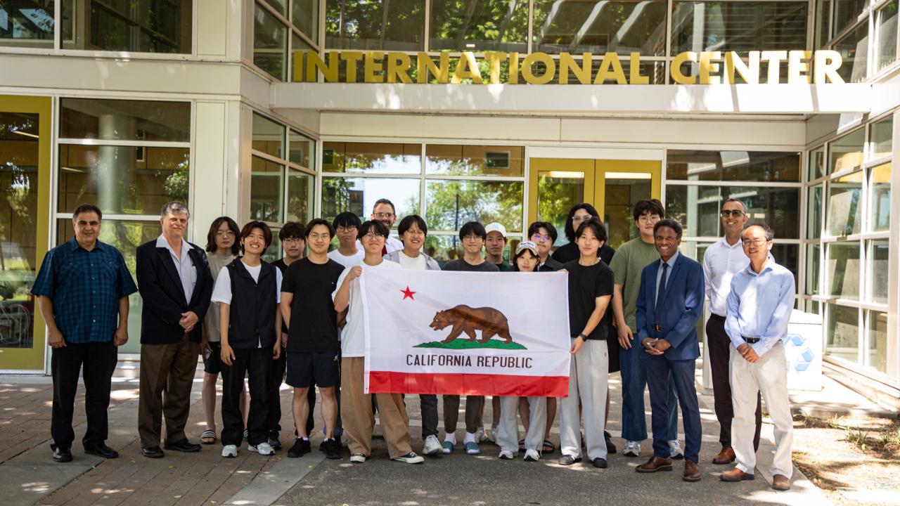 Students from Korea University hold up the flag of California