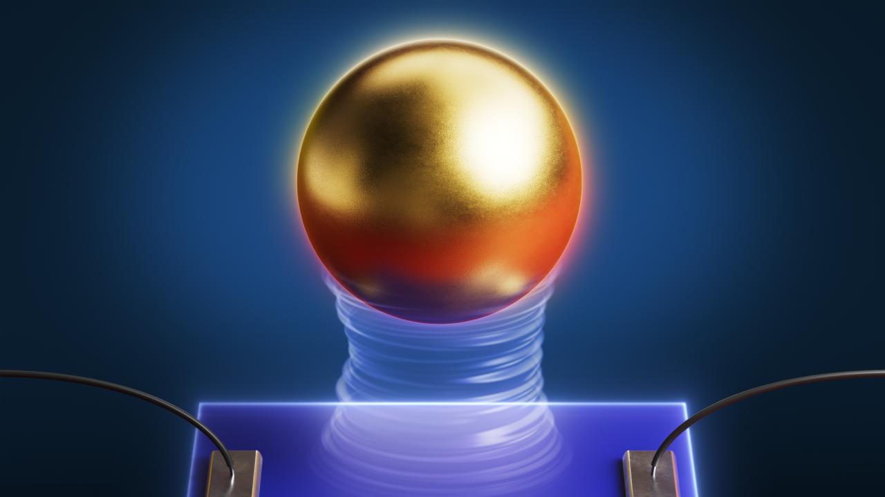 A gold sphere levitates over a semiconductor