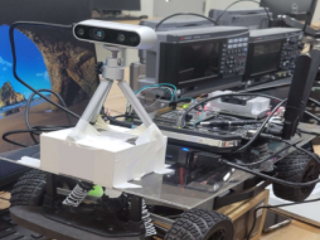 A black and white mini electronic car with a camera attached