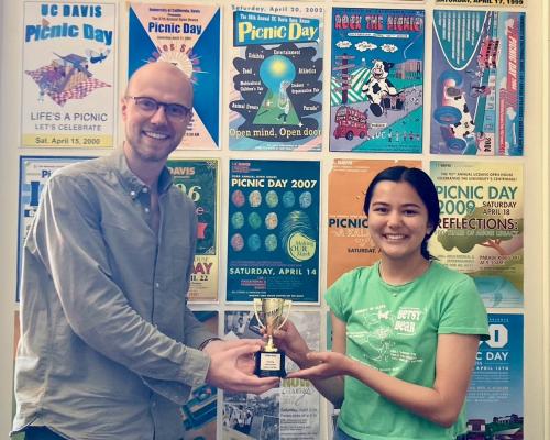 Two UC Davis QCAD members pose with a trophy