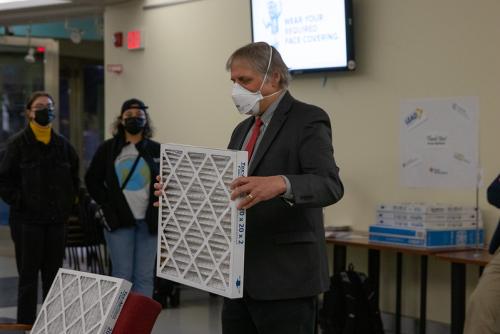 Older white man, Dean Corsi, holding up an air filter