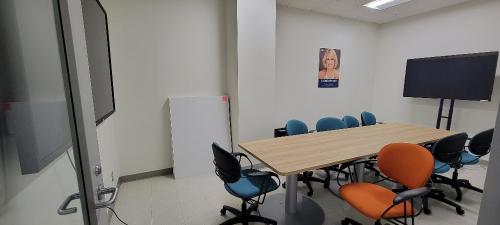 Desk, tables and 2 mounted TVs