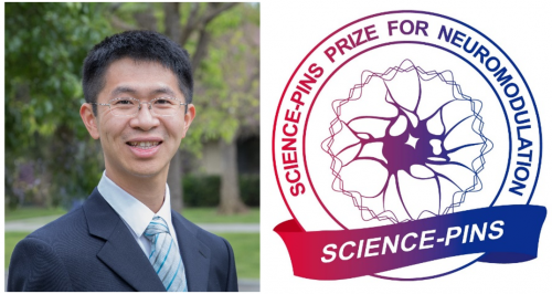 Dr. Yang dressed up in a suit with the AAAS logo next to him