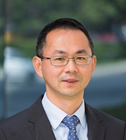 image of man in glasses, suit and tie