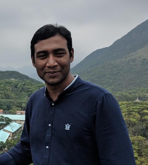 headshot of Shamin Ahamed, foothills in background