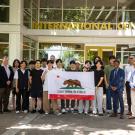 Students from Korea University hold up the flag of California