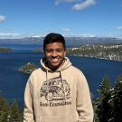 headshot of Pedro background of city topography