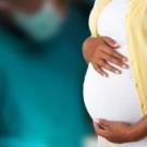 Lady holding her pregnant stomach